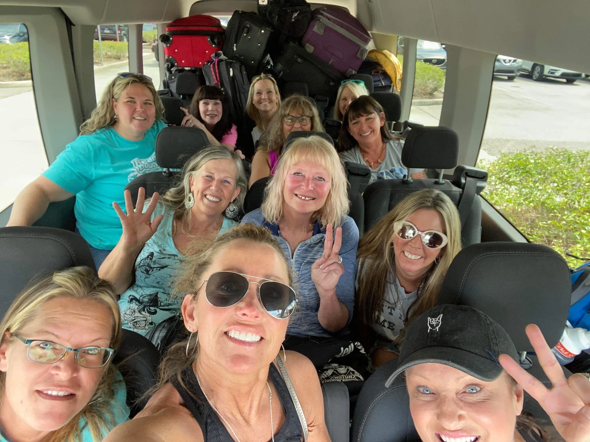 Group of happy passengers smiling inside a spacious Sprinter passenger van